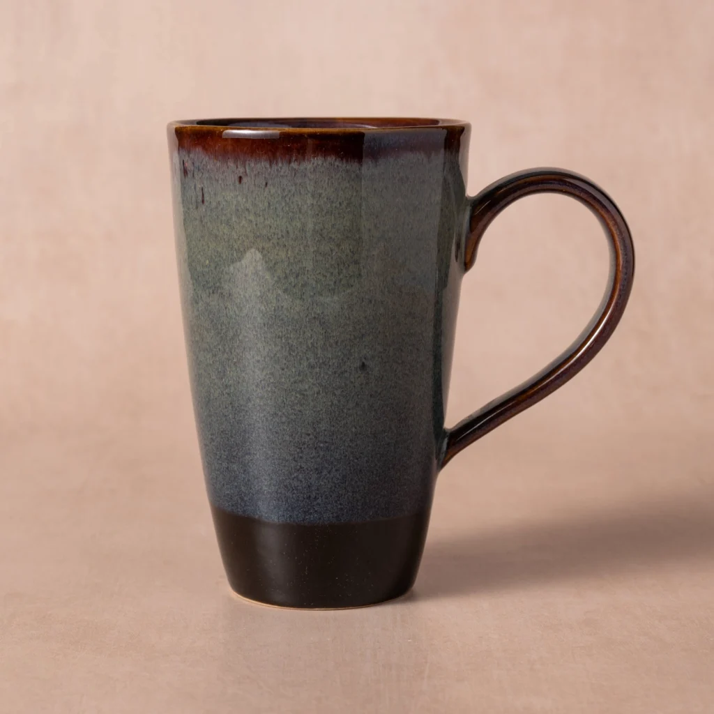 Tall ceramic mug with gray-blue drip glaze and a dark brown handle and base.